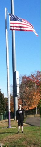 President Keane stands under Old Glory