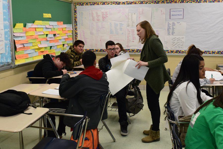 Mrs. Fitzell-Stevens working with her Social Commentary students. 