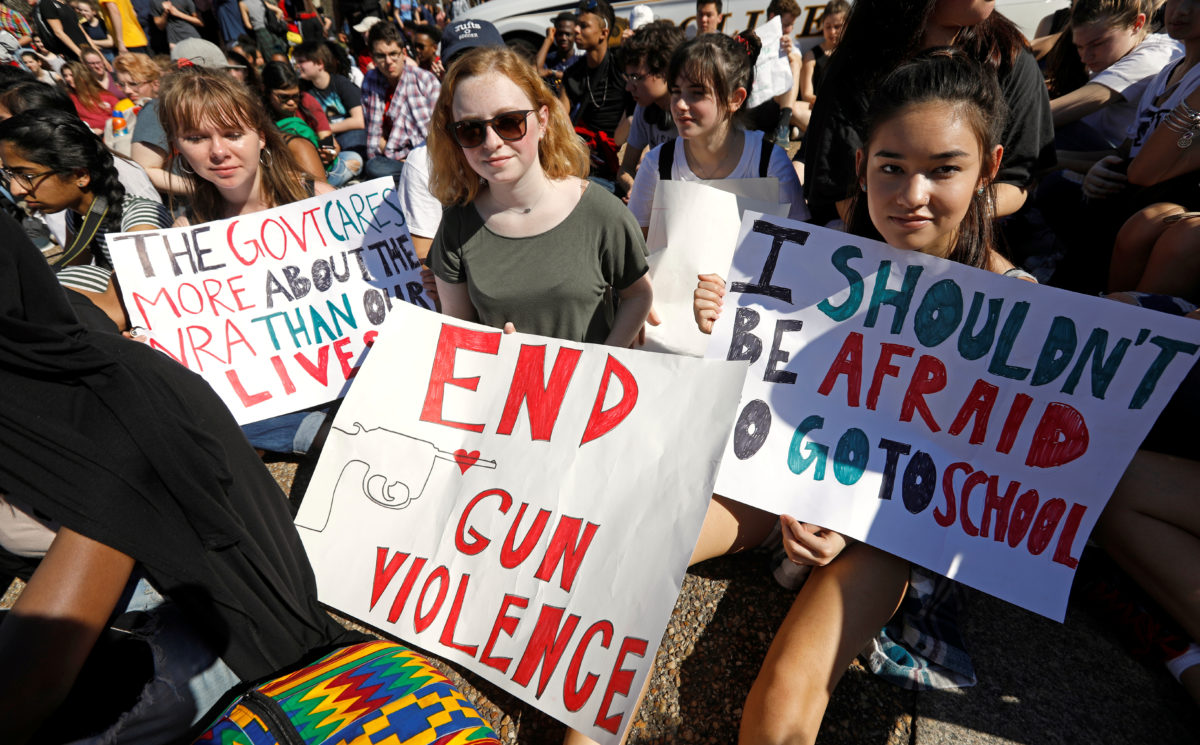 Students who walked out of their Montgomery County, Maryland, schools protest against gun violence in front of the White House in Washington, U.S., February 21, 2018. REUTERS/Kevin Lamarque - RC164B322F90