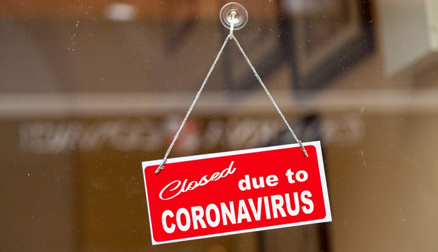 Red+sign+hanging+at+the+glass+door+of+a+shop+saying+Closed+due+to+coronavirus.